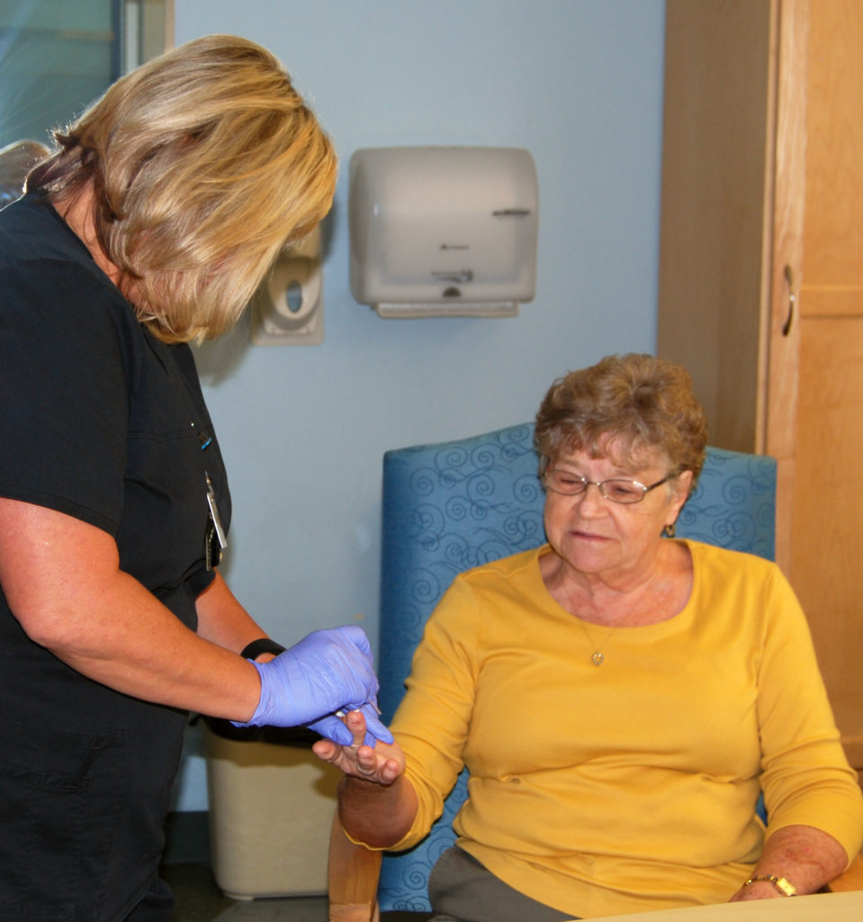 Patient in yellow shirt being examined for cardio